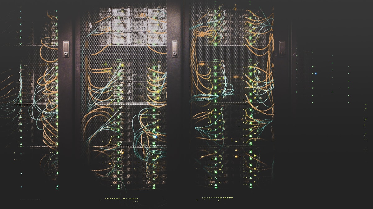 Interior of a data center with rows of server racks and blue lighting